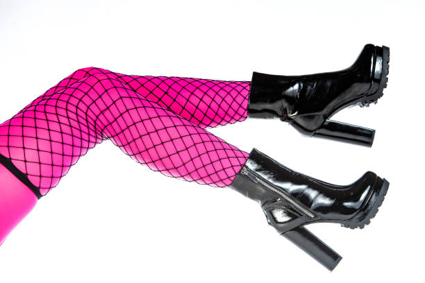 istock Woman´s legs in fishnets with shiny High Heels ankle boots 1185922228