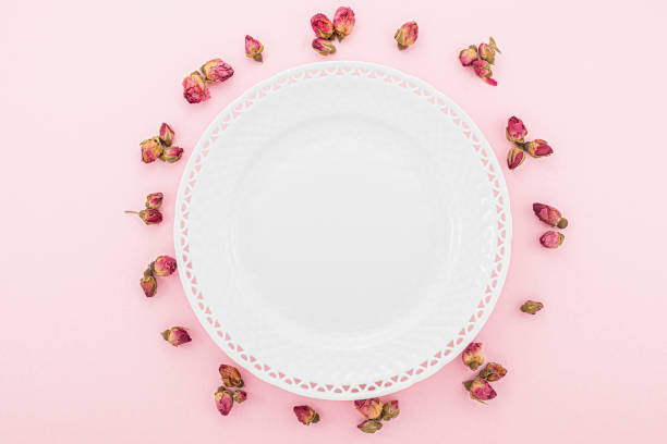 Lacy porcelain plate on rose table