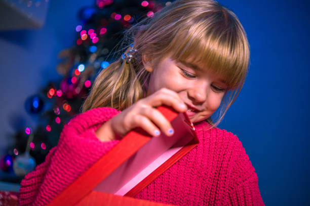 istock little girl holds the gift 1185924422