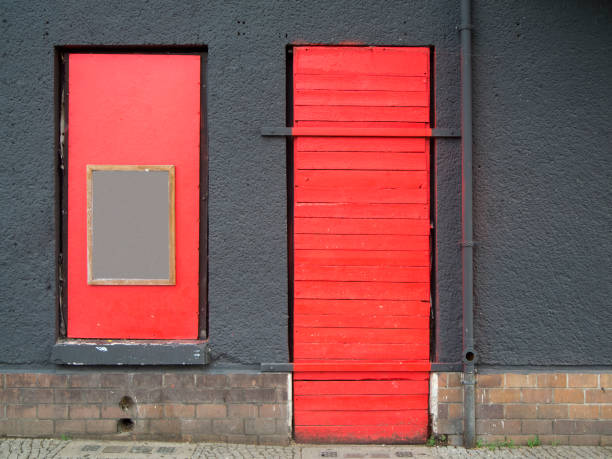 istock red door in a gray wall_horizontal 1185924981