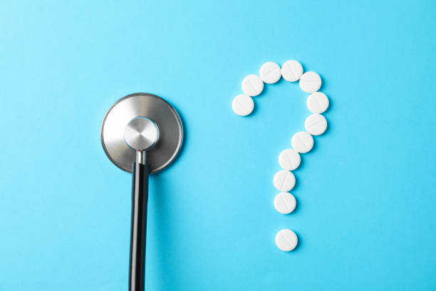 istock Pills and stethoscope on blue background, close up 1185926615