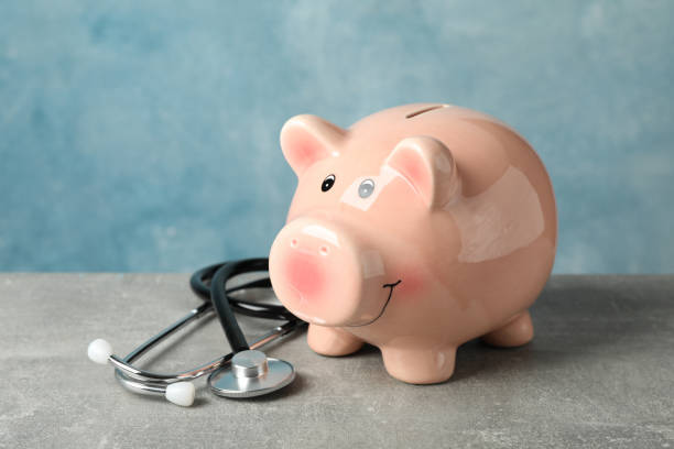istock Stethoscope and piggy bank on grey background, space for text 1185927699