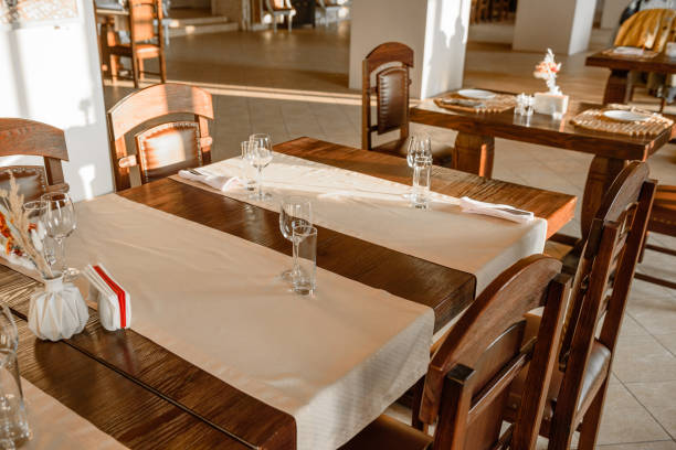 istock Glasses, flower fork, knife served for dinner in restaurant with cozy interior 1185927828