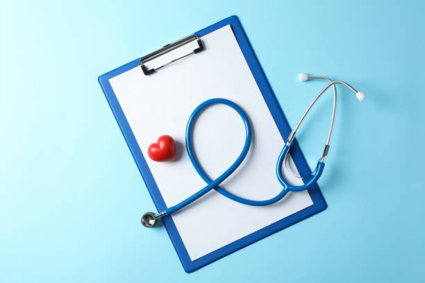 istock Stethoscope and heart on blue background, space for text 1185928046