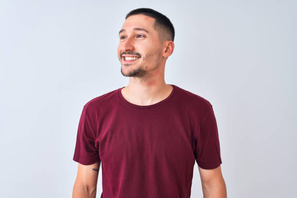 istock Young handsome man standing over isolated background looking away to side with smile on face, natural expression. Laughing confident. 1185933334