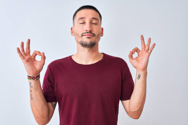 istock Young handsome man standing over isolated background relax and smiling with eyes closed doing meditation gesture with fingers. Yoga concept. 1185933383