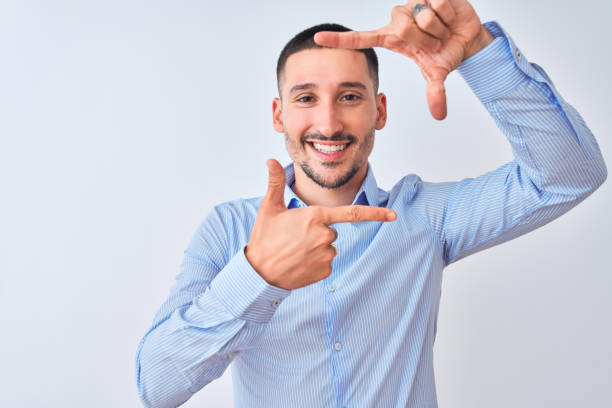 istock Young handsome business man standing over isolated background smiling making frame with hands and fingers with happy face. Creativity and photography concept. 1185933413