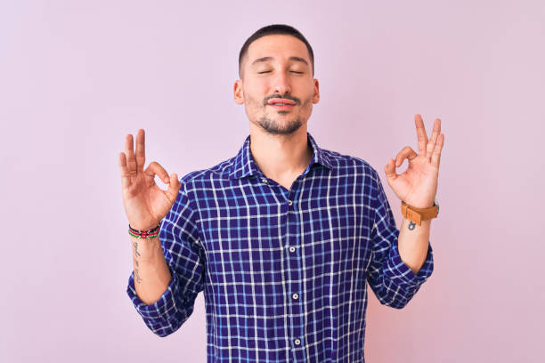 istock Young handsome man standing over isolated background relax and smiling with eyes closed doing meditation gesture with fingers. Yoga concept. 1185934305