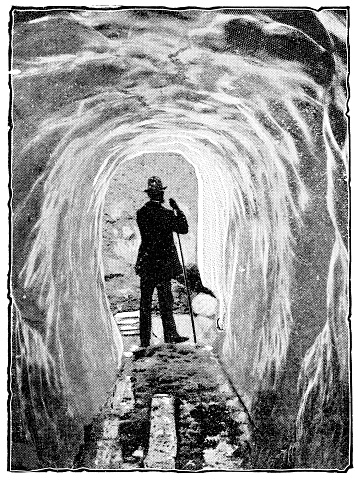 Hiker in the ice cave at Lower Grindelwald Glacier in Bern Canton, Switzerland. Vintage halftone etching circa late 19th century.