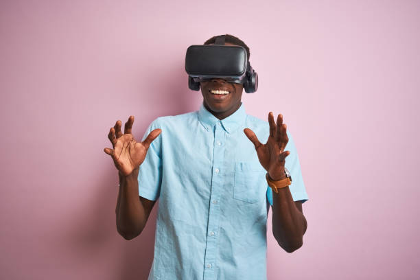 istock Young african american man playing virtual reality game using goggles 1185937553