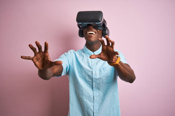 istock Young african american man playing virtual reality game using goggles 1185937590