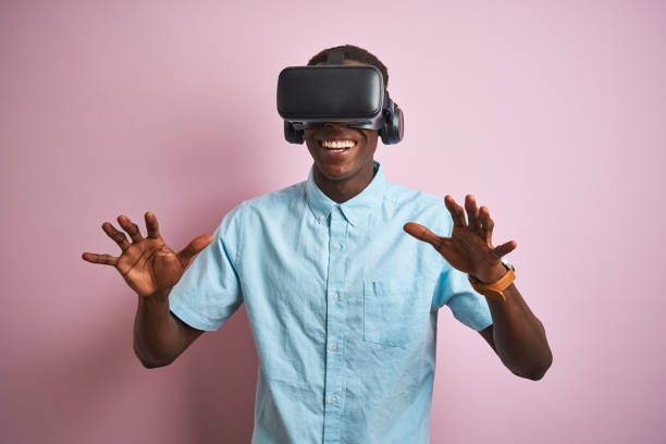 istock Young african american man playing virtual reality game using goggles 1185937609
