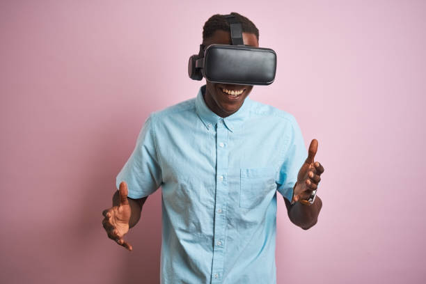 istock Young african american man playing virtual reality game using goggles 1185937612