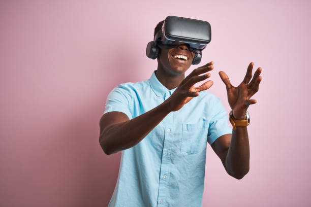 istock Young african american man playing virtual reality game using goggles 1185937758