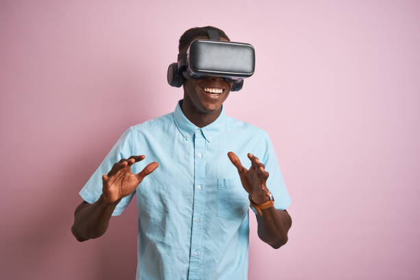 istock Young african american man playing virtual reality game using goggles 1185937825