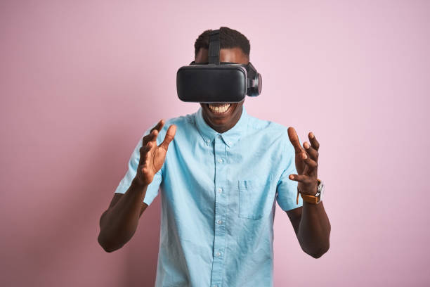 istock Young african american man playing virtual reality game using goggles 1185937830