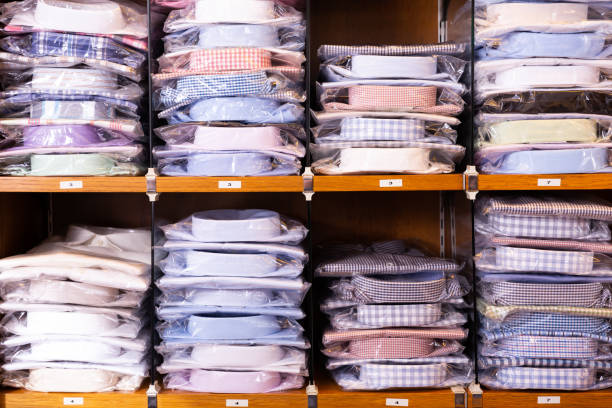 istock Shirts on shelves in shop 1185939081