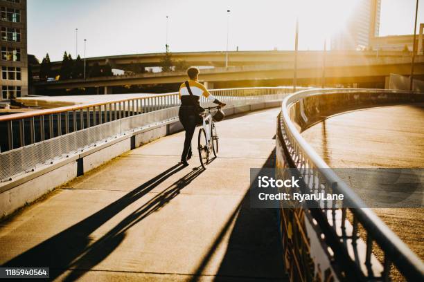 Young Woman With Bike And Messenger Bag In The City Stock Photo - Download Image Now