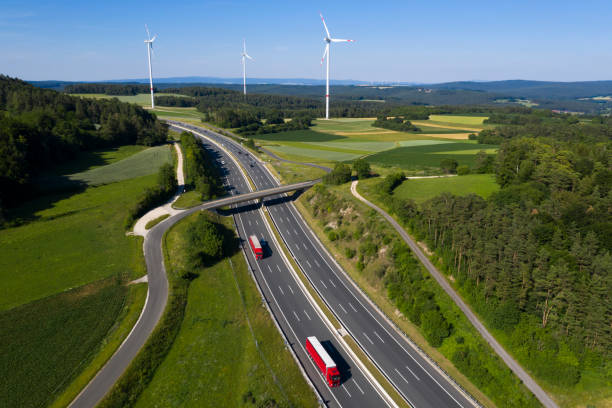 istock Trucks on Highway and Wind Turbines, Aerial View 1185943442