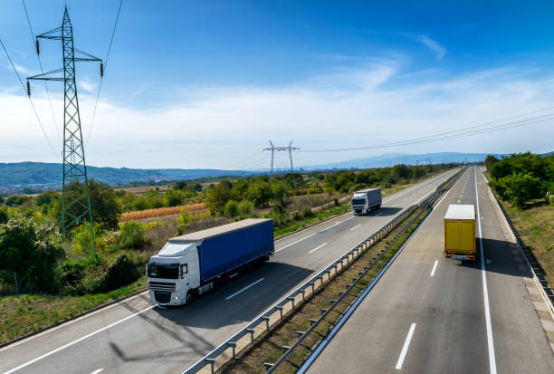 istock Lorry trucks passing by on a country highway 1185944173