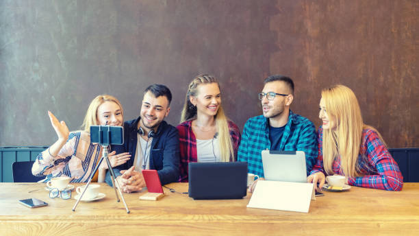 Young happy friends sharing content on streaming platform with digital web camera - Modern influential marketing concept with millennial people having fun vlogging live on social media network