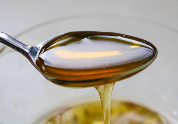 istock natural honey in the spoon 1185947193