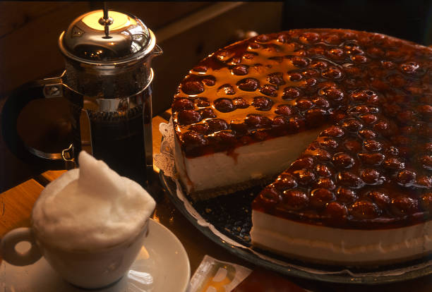 Delicious cherry cheesecake and coffee pleasure. Cafe, bakery, sweets and coffees concepts. Horizontal close-up detail.