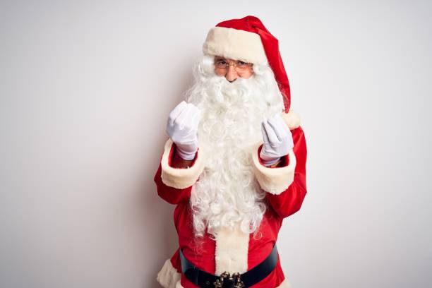 istock Middle age handsome man wearing Santa costume standing over isolated white background doing money gesture with hands, asking for salary payment, millionaire business 1185949077