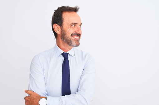 Middle age businessman wearing elegant tie standing over isolated white background smiling looking to the side and staring away thinking.