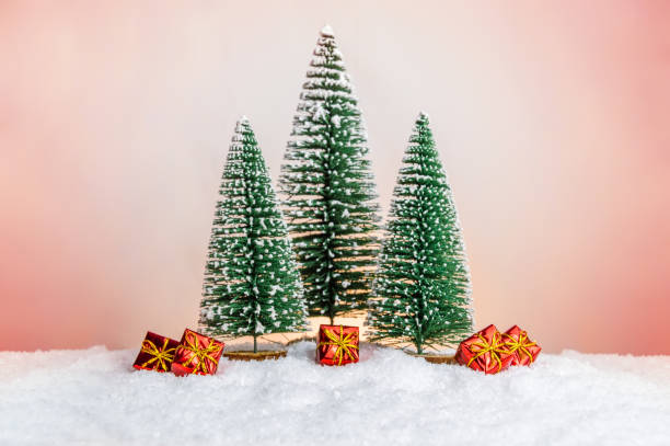 istock Many small presents under Christmas tree in miniature forest on snow 1185950984