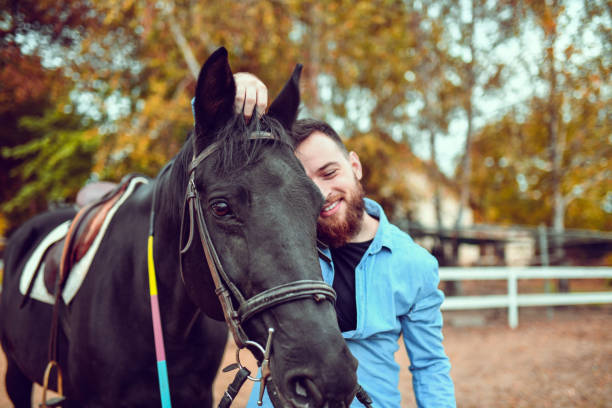 istock Male Embracing His Mare On Ranch 1185952262