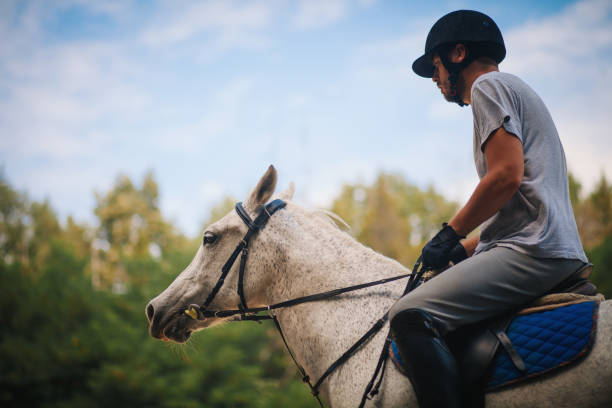 istock Jockey riding horse at barn 1185952841