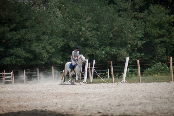 istock Jockey riding horse at barn 1185952856