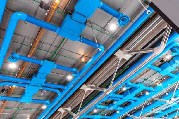 istock Industrial building ceiling with ventilation system pipes 1185953626