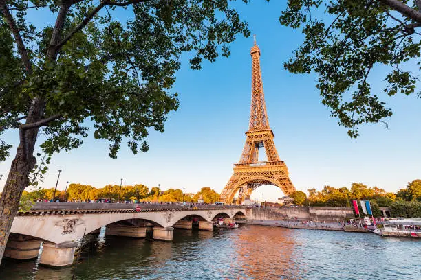 Photo of Panoramic view of Eiffel tower and Seine river at golden sunset. Travel landmarks in Europe and France