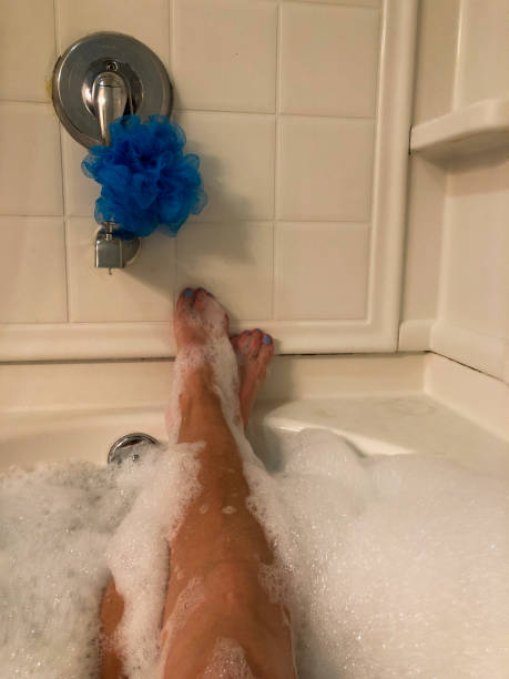 istock Female soaking in bubble bath with legs in view 1185954013