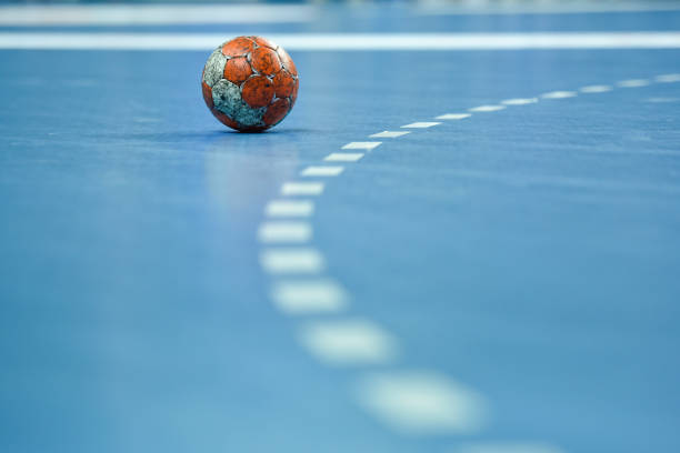 handball Match ball lying on the parquet near 9 m line. handball stock pictures, royalty-free photos & images