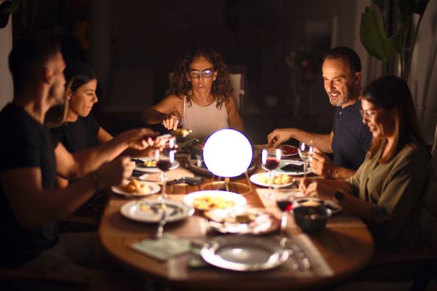 istock Beautiful family on dinner talking and smiling at terrace 1185955264