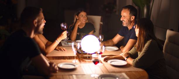 istock Beautiful family on dinner talking and smiling at terrace 1185955295