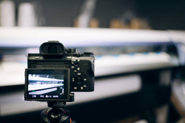istock Videographer using camera slider, making video of business at factory. 1185955683