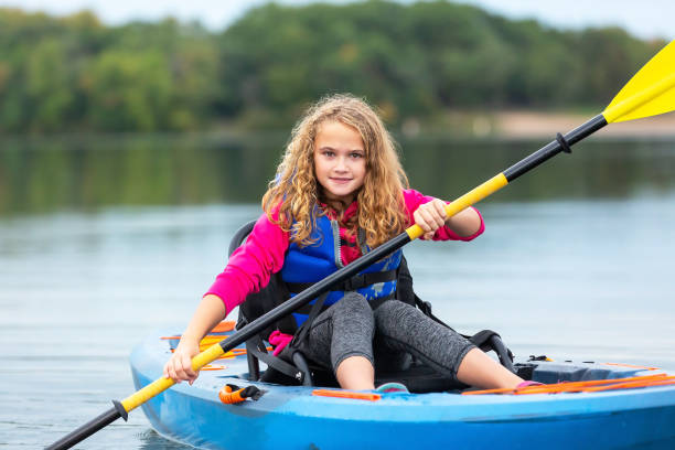 istock Young Girl Kayaking and Looking at Camera 1185956532