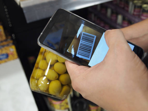 hand using a bar code reader app on a olive jar - bar code reader wireless technology computer equipment imagens e fotografias de stock