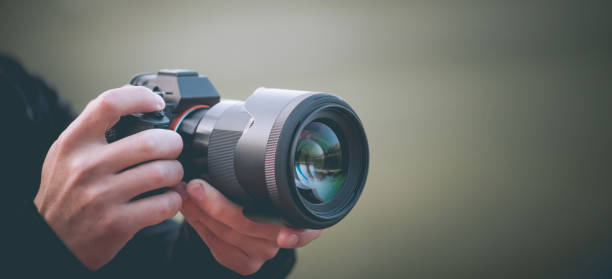 istock Man taking picture with photo camera, modern technology, close-up 1185975032