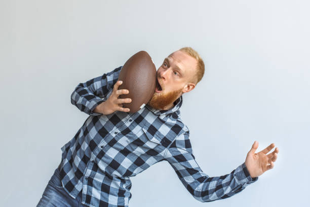 istock Freestyle. Mature man bending aside isolated on grey got face hit with ball unexpected 1185978155