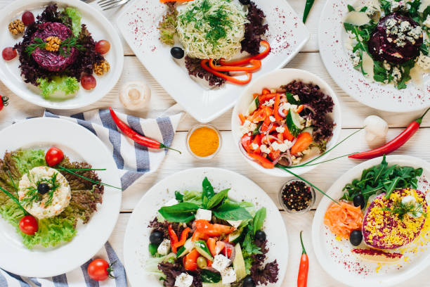 istock festive banquet table vegetable salads assortment 1185978182