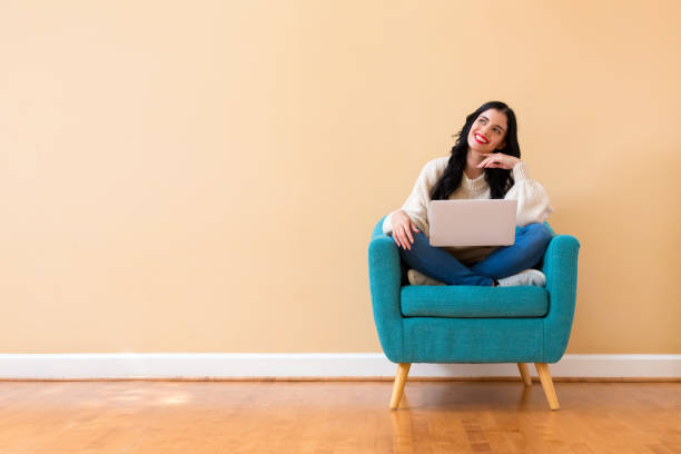istock Young woman with a laptop computer in a thoughtful pose 1185978706