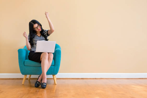 istock Young woman with a laptop computer with successful pose 1185978723