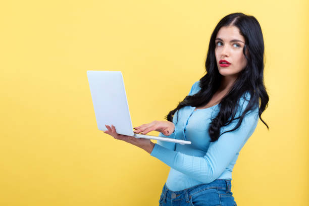 istock Young woman with a laptop computer 1185978761