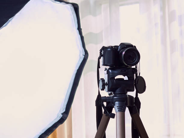 istock Photo camera on a tripod and white background. 1185981028