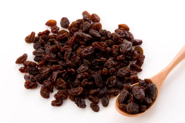 istock Dried raisins in a wooden spoon 1185981878